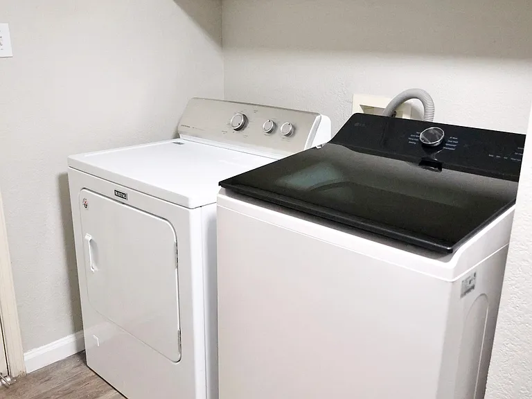 Laundry room with washer and dryer included.
