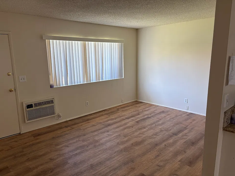 Living Area with wall A/C and new laminate flooring