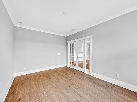 The desirable modern flex room with French doors can be utilized as a private study or task room.