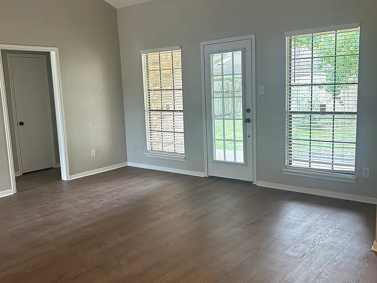 The back of the living area leads to the covered patio and backyard.