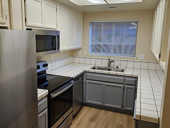 Fully equipped kitchen with new fridge, range, microwave and full size dishwasher. Tons of storage and a wine rack!