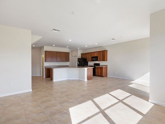 Open concept kitchen and gathering room with tile floors