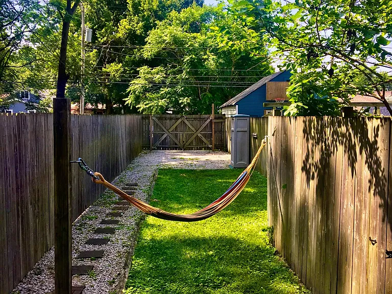 Hammock, deck and perfect size back yard for fire pit, bbq's and gardening.