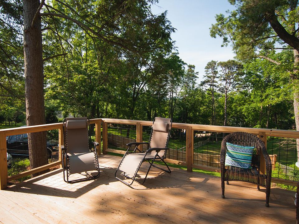 Back deck accessible from kitchen. Parking to the left in photo.