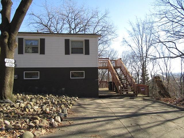 Imagine yourself next summer sitting out on the shaded upper deck with the cool breeze coming up from the ravine. Lawncare included. Driveway allows 2 medium cars for each unit.