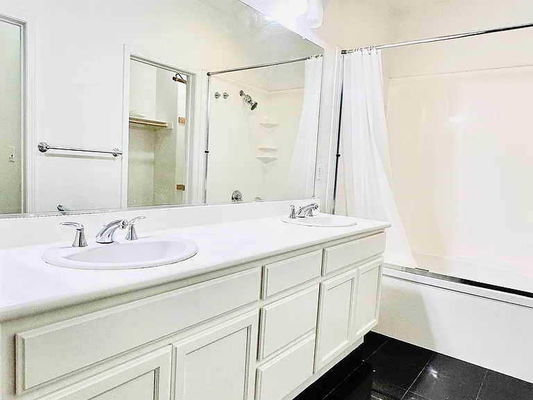 Luxurious en-suite bathroom with double vanities and a separate toilet room.