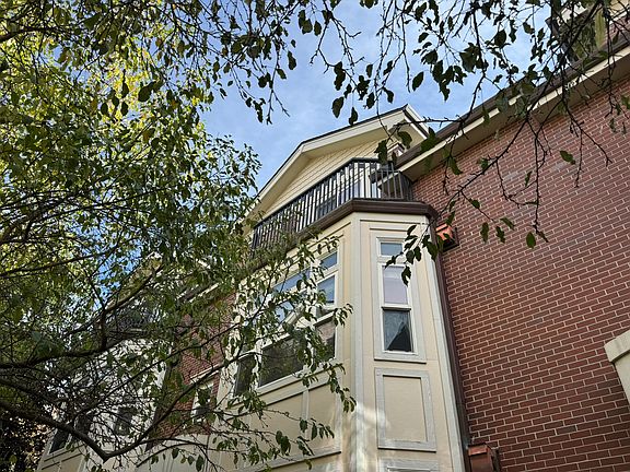 High above is the balcony of the master bedroom that overlooks green area. Right below is the main living room window to the green area.