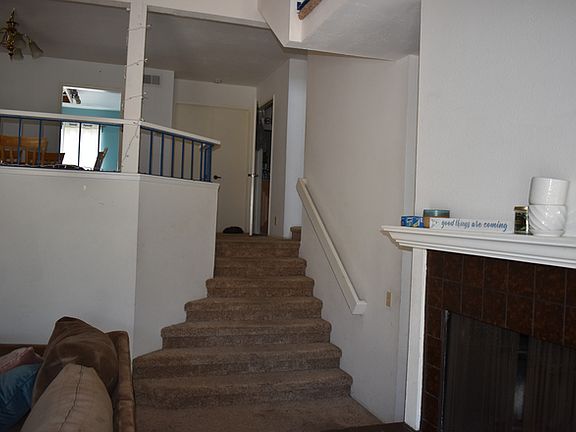 Living room and stairs to second level dining room, kitchen, bedroom and half bath.