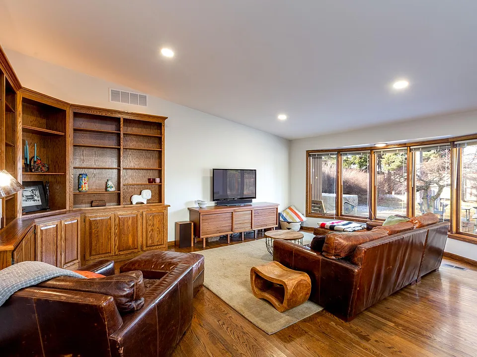 Large living room with vaulted ceiling and skylight.