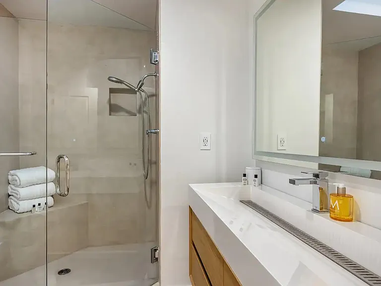 Revitalize in the ensuite bathroom, adorned with a bidet, large bathtub, and hotel-style amenities.