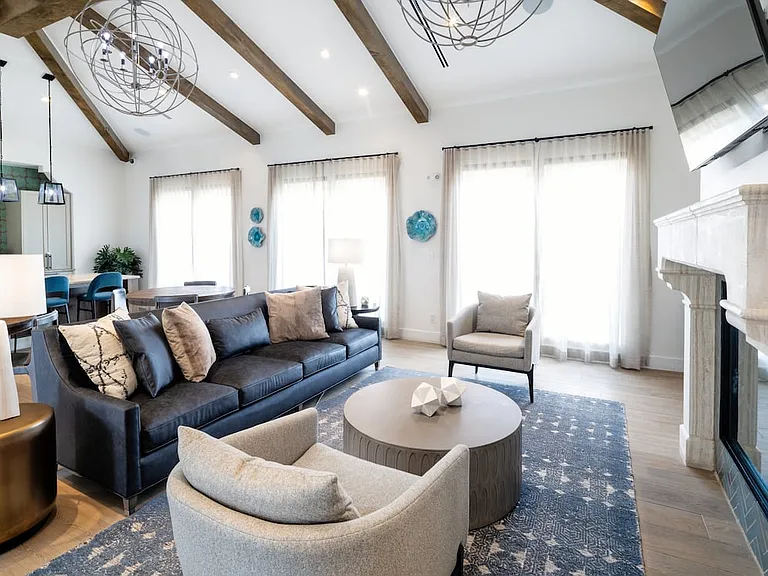 Resident lounge with multiple seating areas and a fireplace