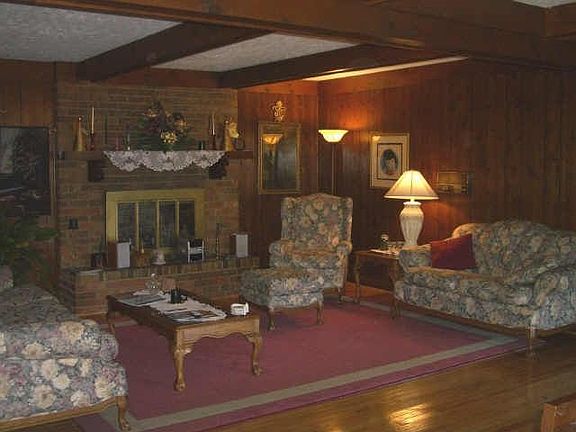 Spacious formal living room with cozy masonary fireplace