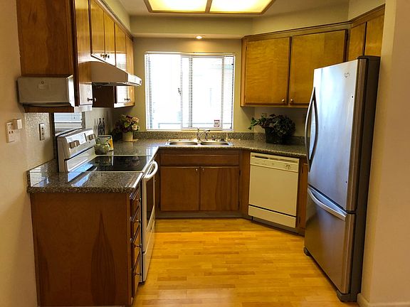 Kitchen with Granite countertops, high power rangehood, SS refrigerator with spacious freezer room, halogen stove & oven, dishwasher, garbage disposer...