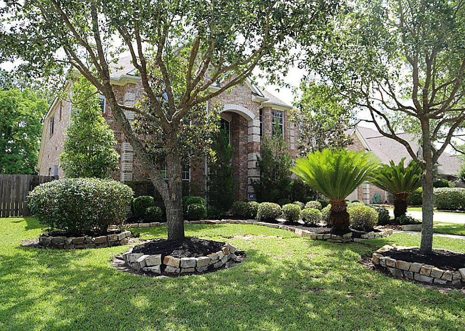 Nice mature trees and lush landscape greet your guests.