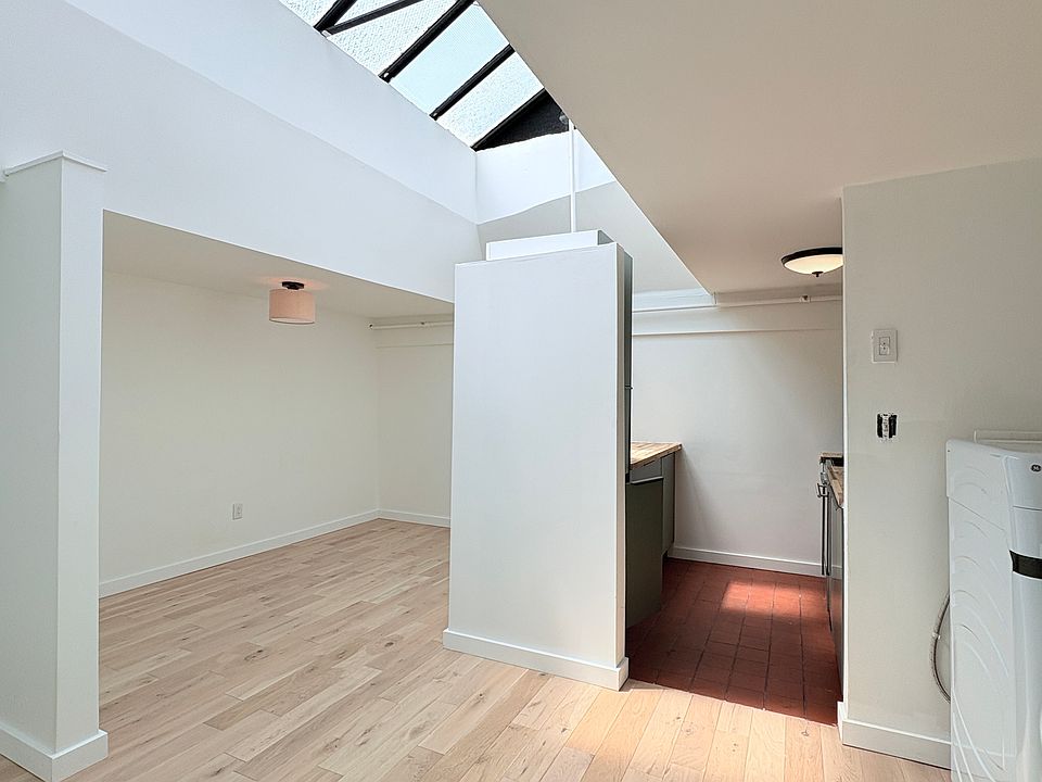 Living Area (l) and Kitchen from Apartment Entrance