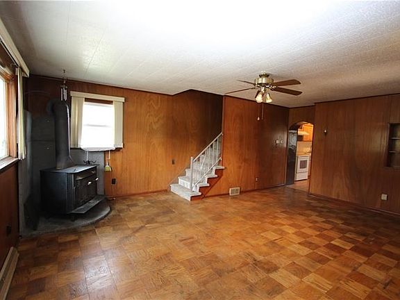 Large 20x12 Living Room w/ Beautiful Paquet Wood Flooring, Wood Stove & Ceiling Fan Light