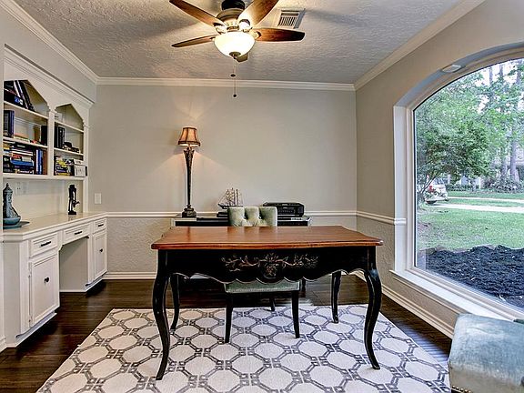 This is a great office space with French doors, built ins and a huge window overlooking the front of the home.