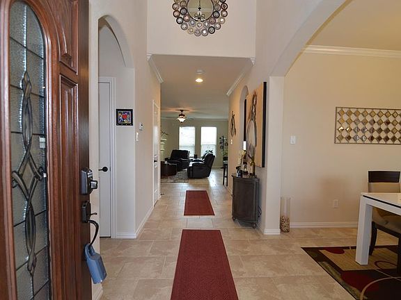 Welcome Home! Enter through the leaded glass front door with side panel to the two story tiled entry!