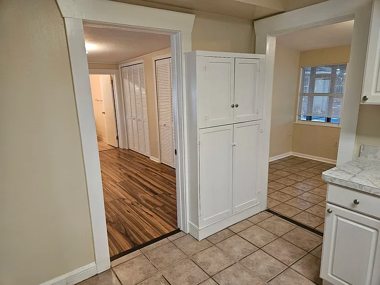 Kitchen into bedroom and into den/dining.