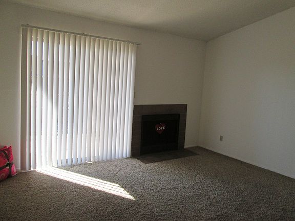 Spacious living room with fireplace and vaulted ceiling.