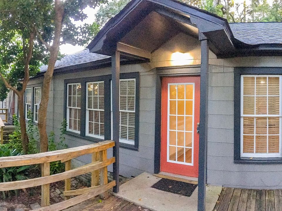 Front entrance with deck and large storage shed.