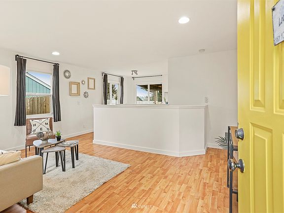 Follow the yellow door into the open spaced rooms.