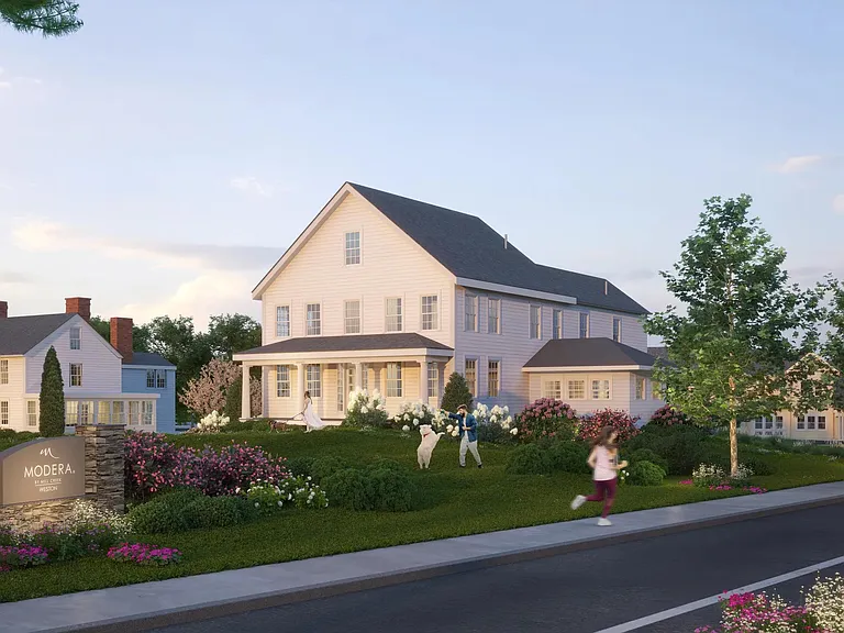 A welcoming community entrance with landscaped grounds, tree-lined streets, and classic New England_inspired architecture.