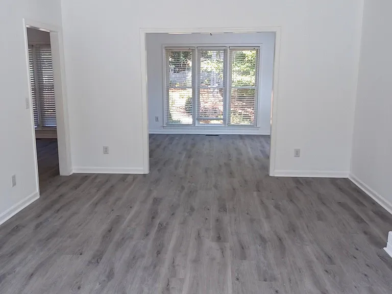 WELCOME HOME ! Brand new special order vinyl flooring throughout the house. Shot from living room to reading room and back porch .