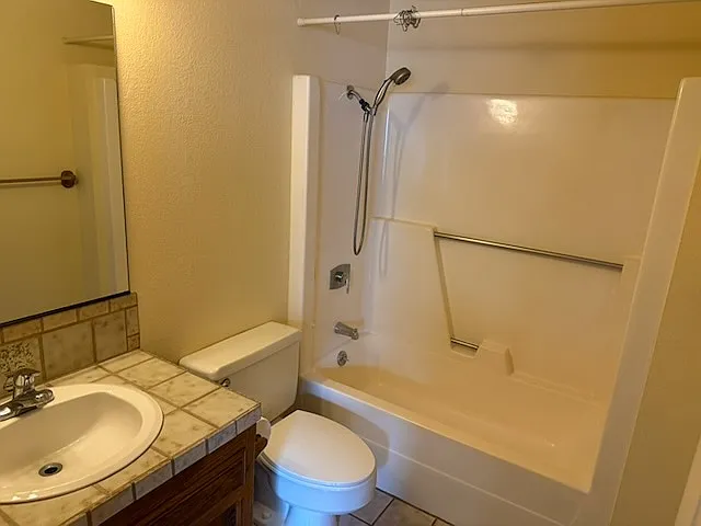 Bathroom in second bedroom. Single sink, tub and shower.