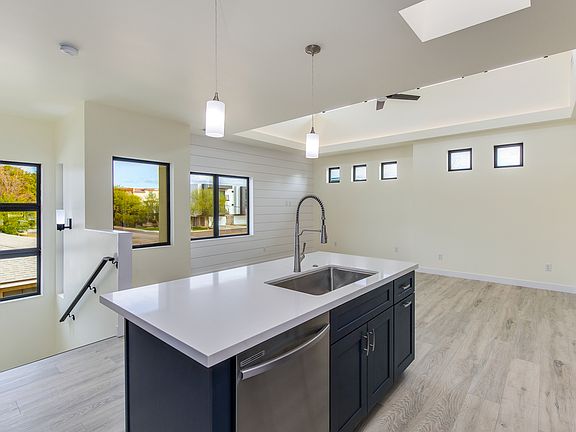 LED backlighting along ceilings in living room and sky-lights