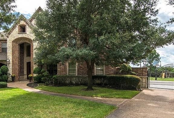 Electric gate adds to the security of this home.