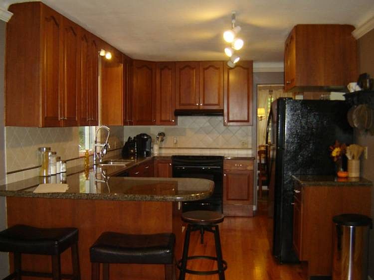 This awesome kitchen is a recipe for success!  It is warm and inviting with wood floors, Owens cherry cabinets, granite counters, newer refrigerator, new lighting,new faucet and hardware.