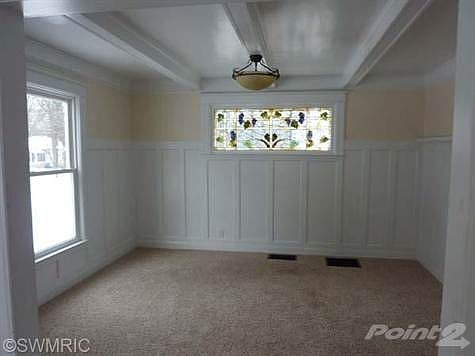 Formal dining room has stained glass window.