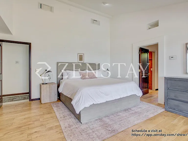 pacious primary bedroom with king bed and serene ambiance