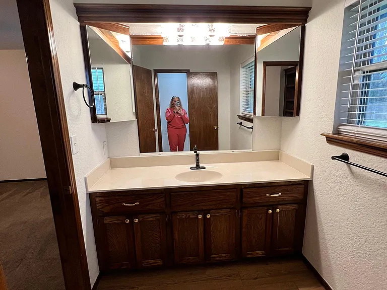 Master vanity. Corner mirrors hold meds etc. behind the door