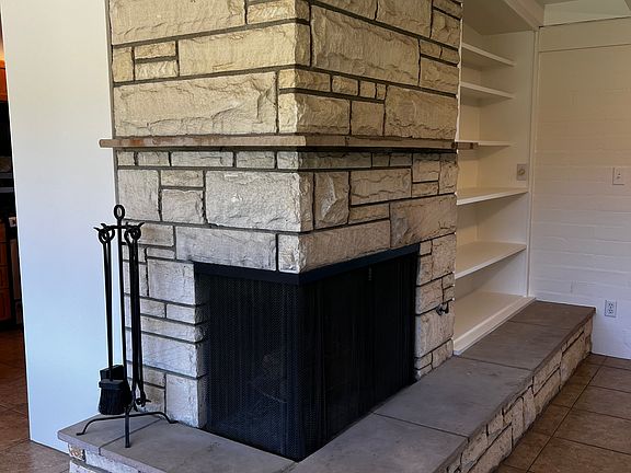 The wood-burning fireplace (with gas starter) warms the room in the winter months and adds mid-century ambiance throughout the year.