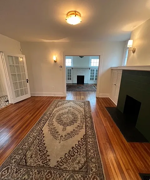 Spacious living room. Brand new light fixtures, Nest thermostat, updated paint, and refinished hardwood floors.