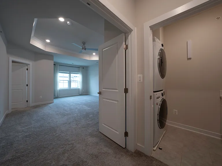 Top floor premium LG brand washer and dryer set in dedicated laundry room. Laundry room contains cabinet storage space above and below countertop. Retractable hanging rod also included.