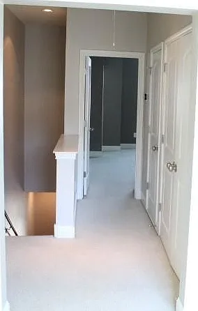 3rd floor hallway view of master, laundry on right