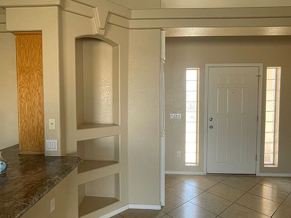 Entry, tile floors, plant shelves, display nooks, hall closet