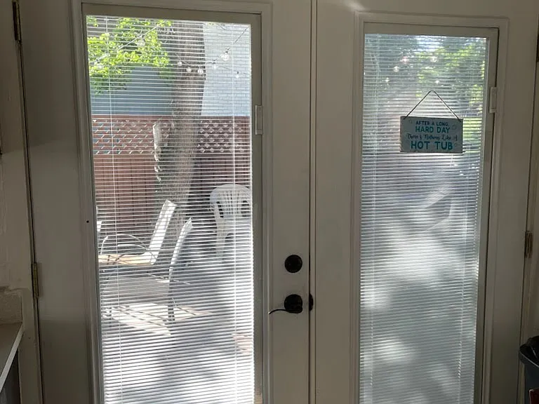 Pretty, new doors from kitchen to huge side porch, fenced back yard, and cedar style soaker hottub.