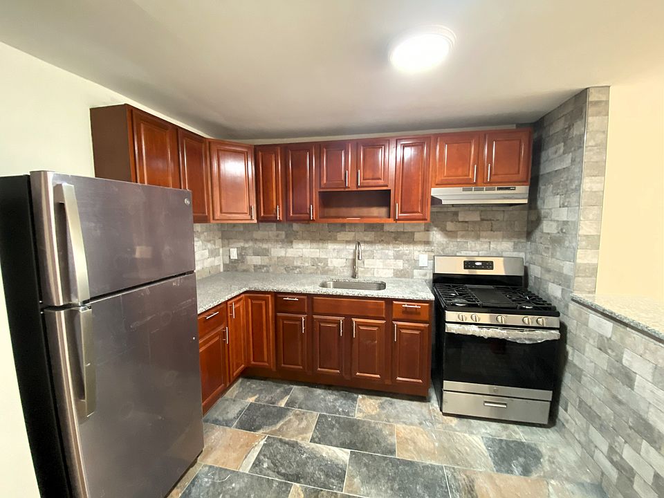 New stainless steel appliances, tile floors and backsplash with granite counters.