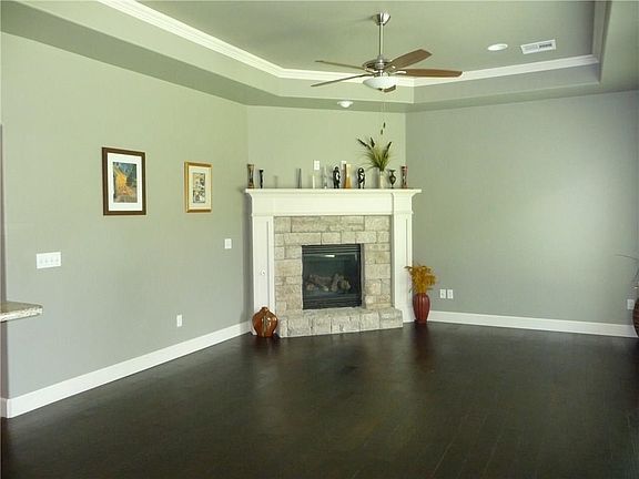 FAMILY ROOM WITH BEAUTIFUL CORNOR FIREPLACE AND WOOD FLOORS