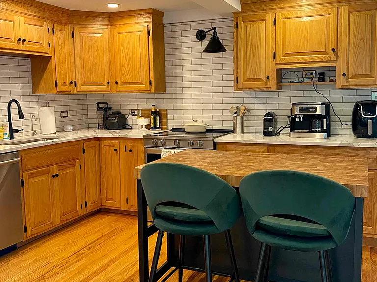 kitchen with stainless appliances, espresso/coffee maker, all cooking and serving items and 2 person bar