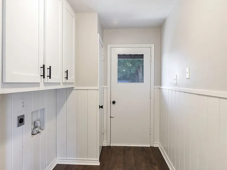 Laundry room with electric dryer hookup, dark wood-type flooring, cabinets, and washer hookup