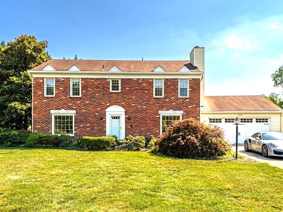Exterior of home with two car garage and off-street parking.