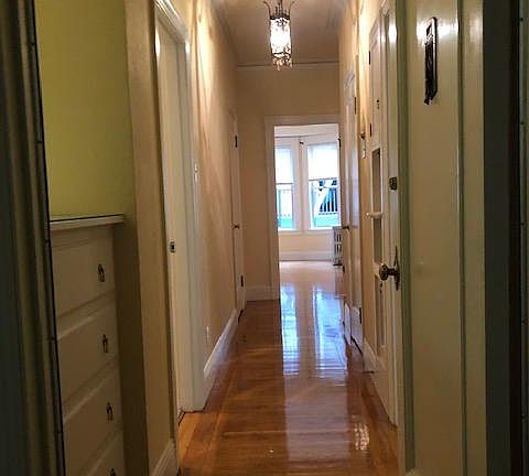 Entry from front door looking down hallway to bedroom