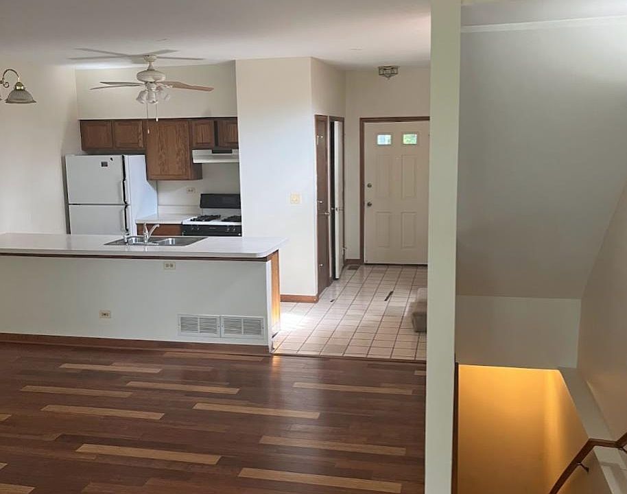 View of living room into the kitchen and foyer.