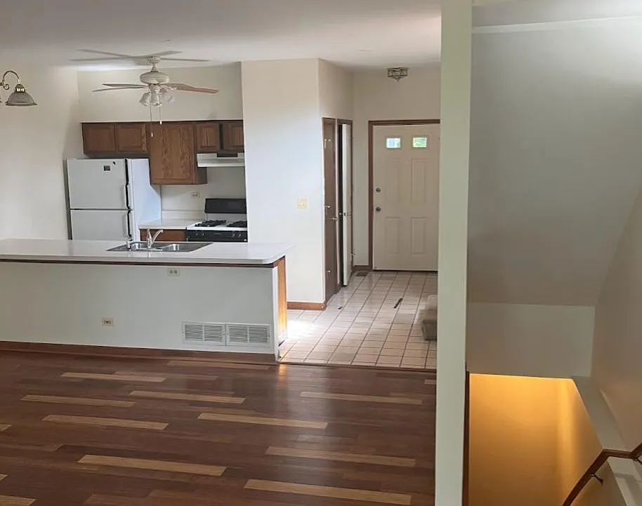 View of living room into the kitchen and foyer.