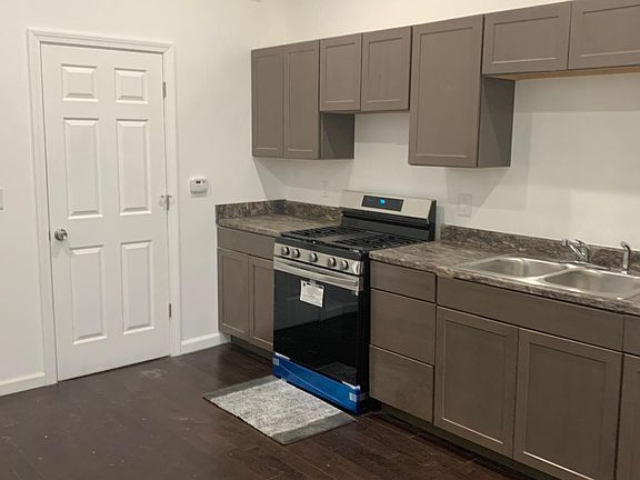 Kitchen with stainless steel refrigerator and stove and hardwood floors